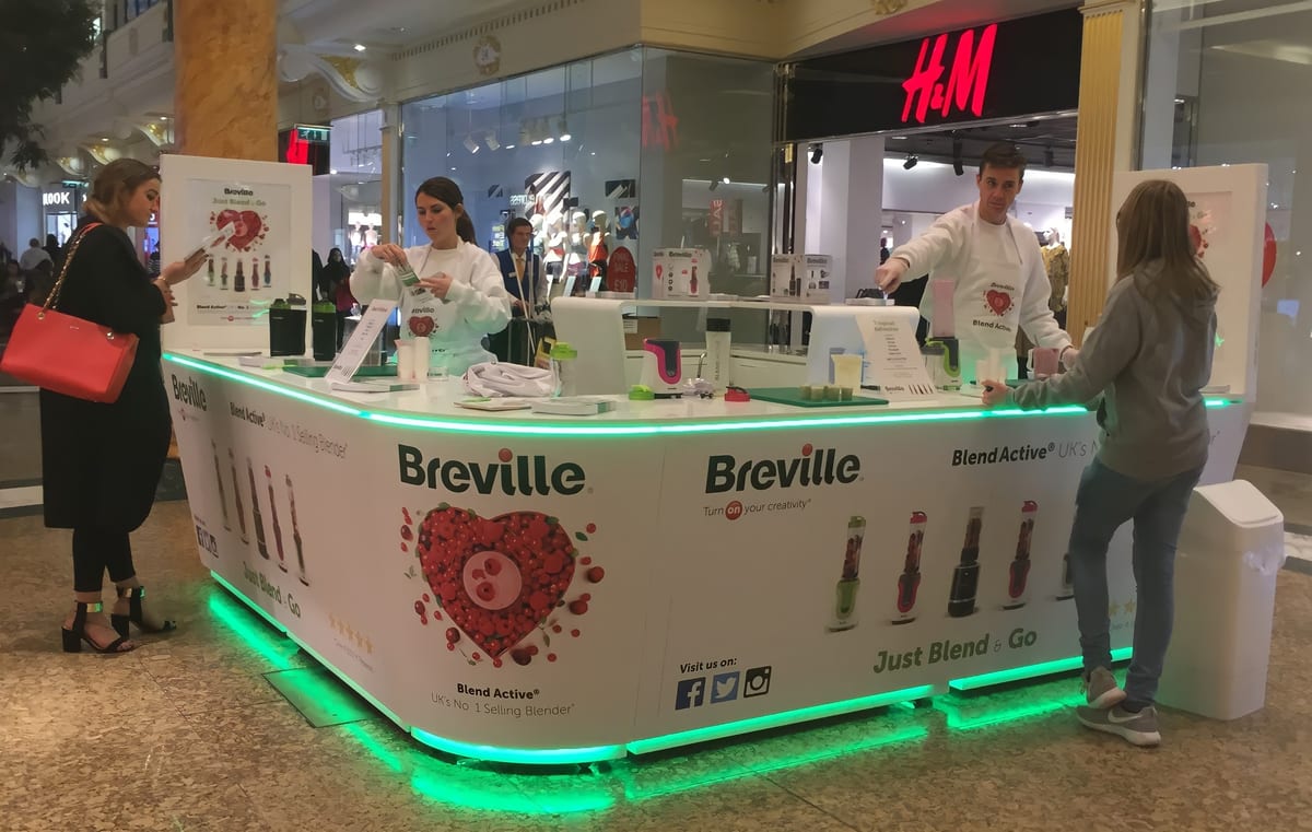Breville demonstration counter with demonstrators in white in a shopping centre