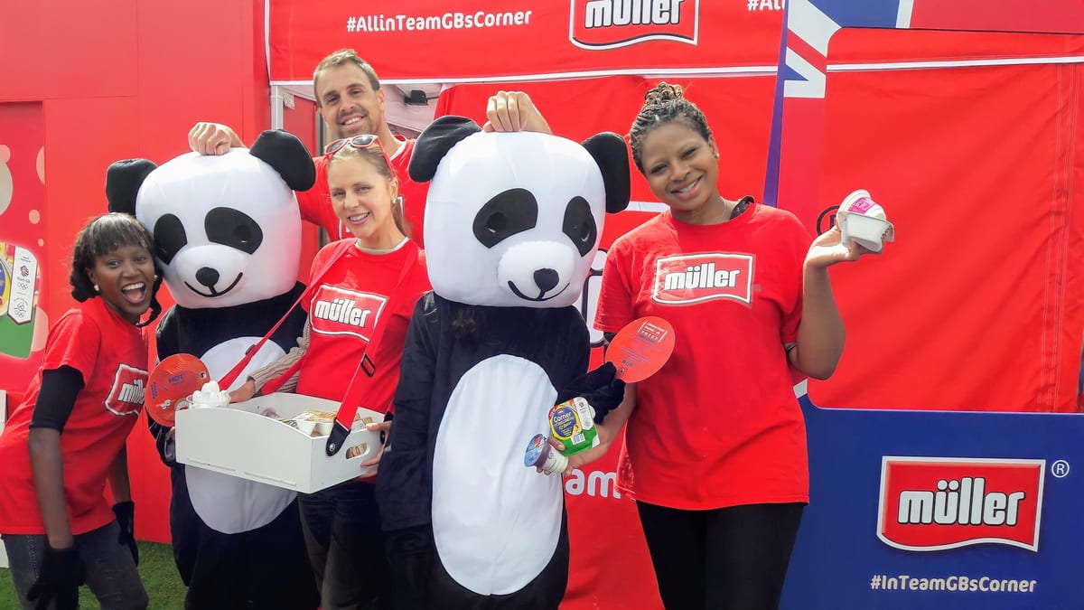 EXECUTIONAL sampling team with Müller mascots at an outdoor event