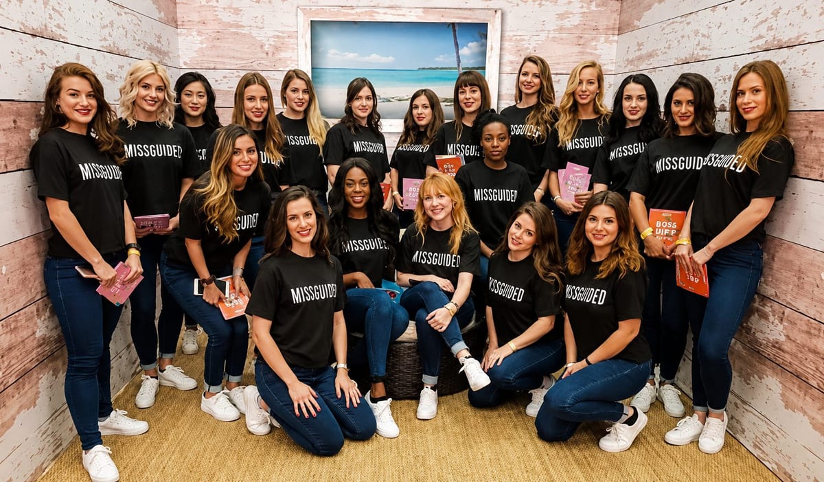 The Missguided team of brand ambassadors in black Missguided T-shirts posing together in front of a beach-themed wall