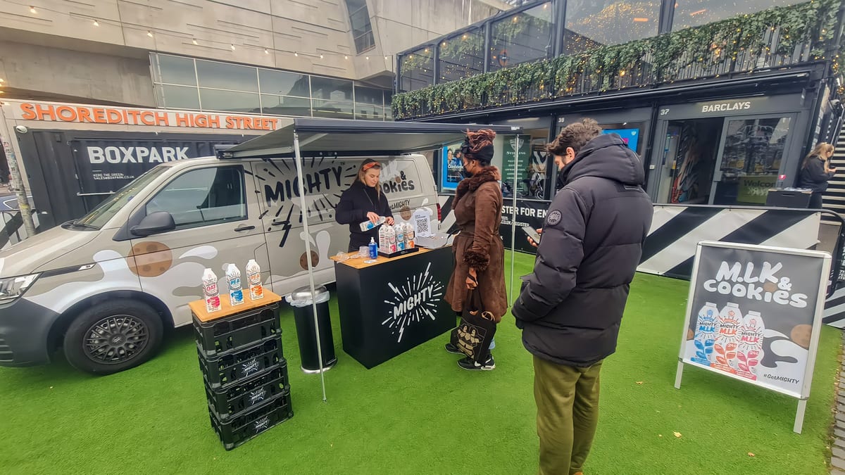 Mighty sampling team at the branded van with a display of drinks