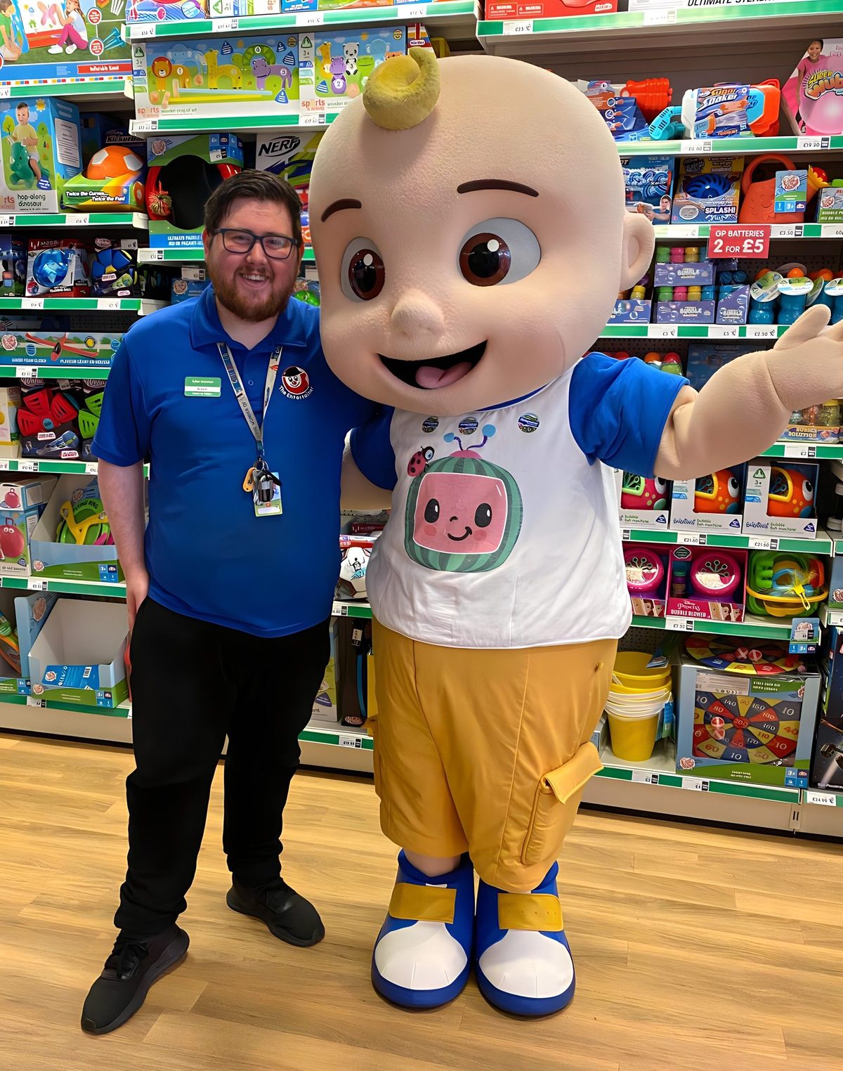 Costumed character greeting children and families during a store event day