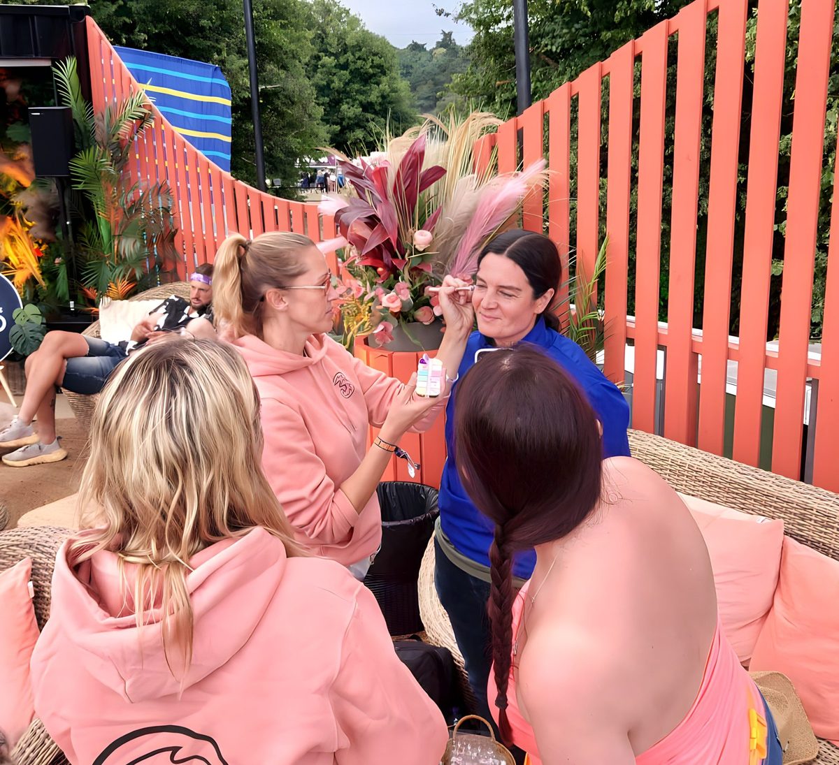 A Three team member with festival-goers on the decorated platform