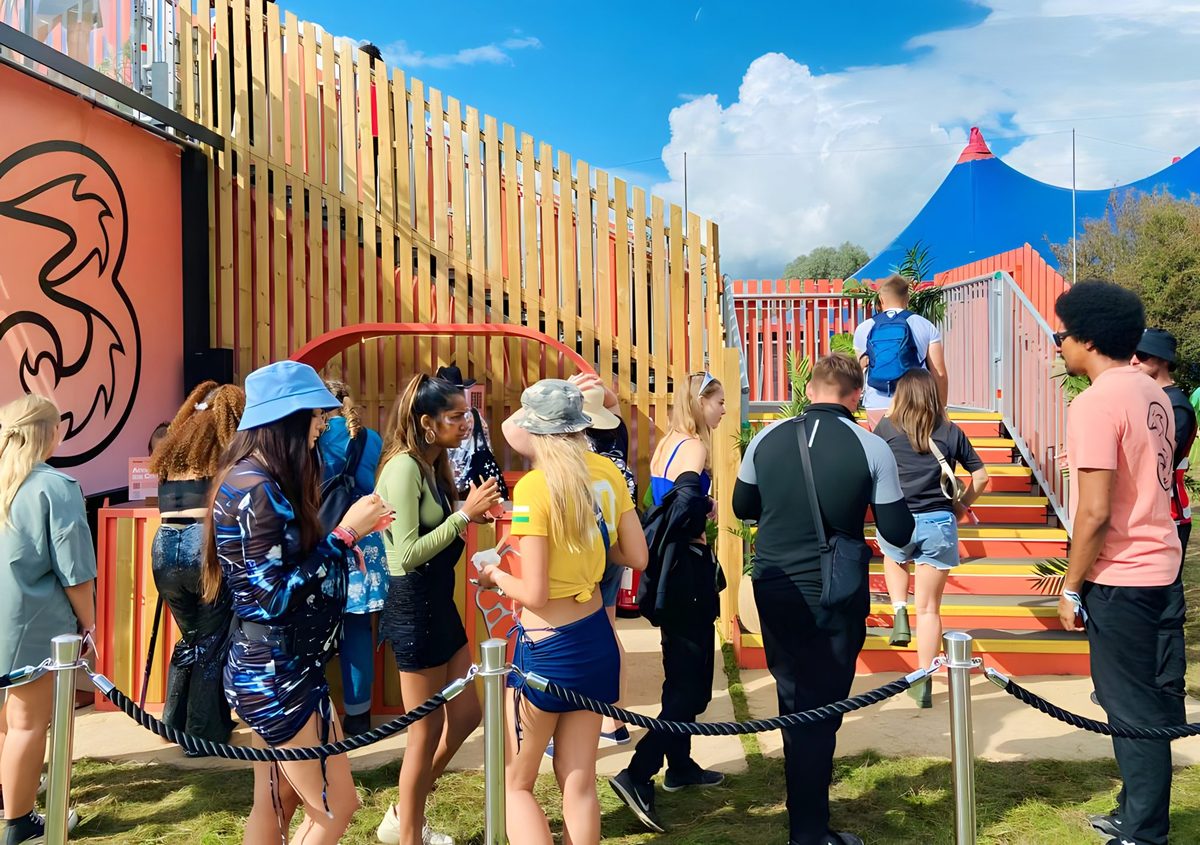 Festival-goers queueing for the stairs up to the Three VIP platform