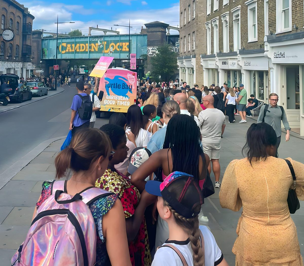 promotional staff serving from a decorated ice cream van on a Camden street