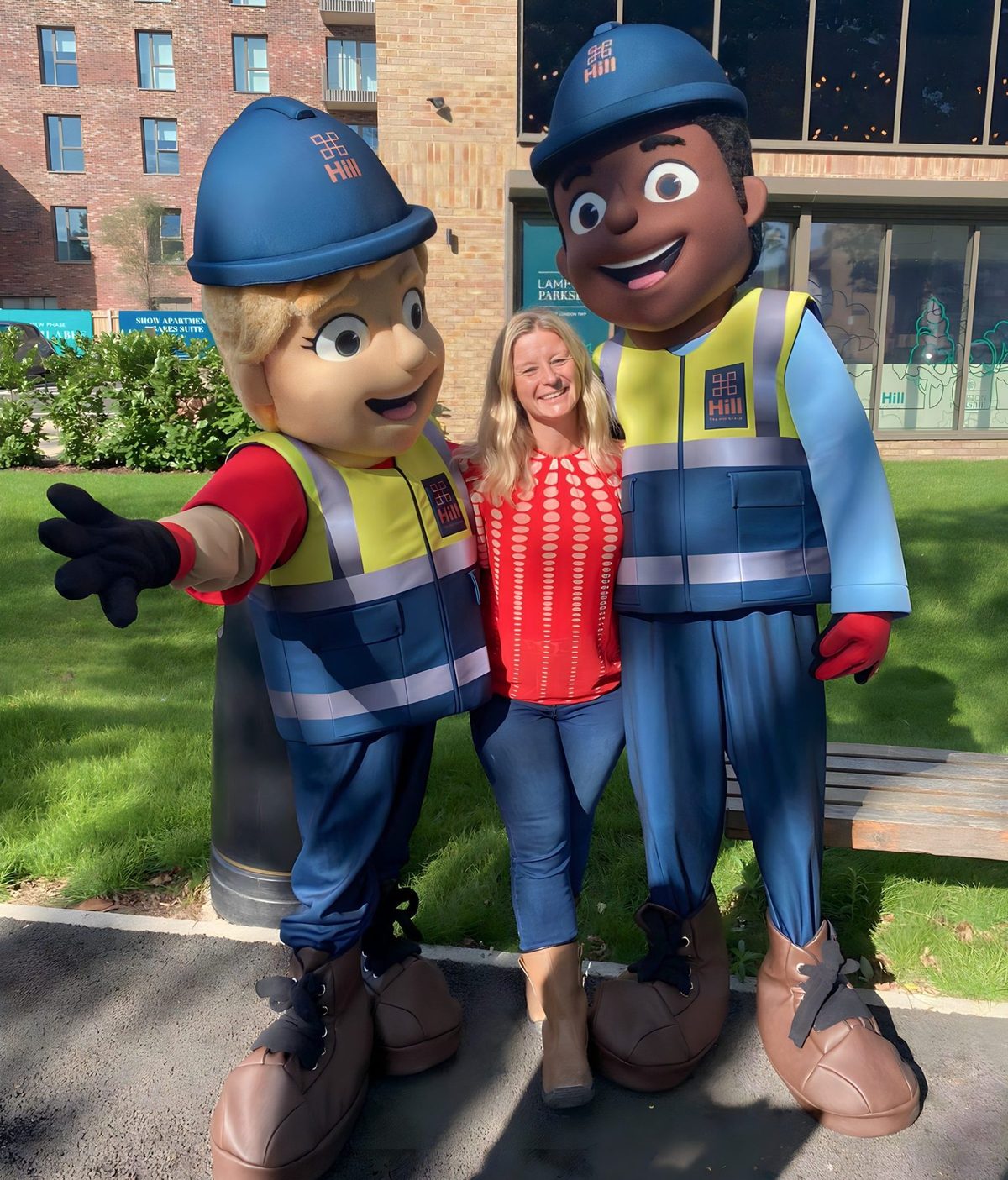 Hill Group costumed characters with a brand team member at an outdoor event