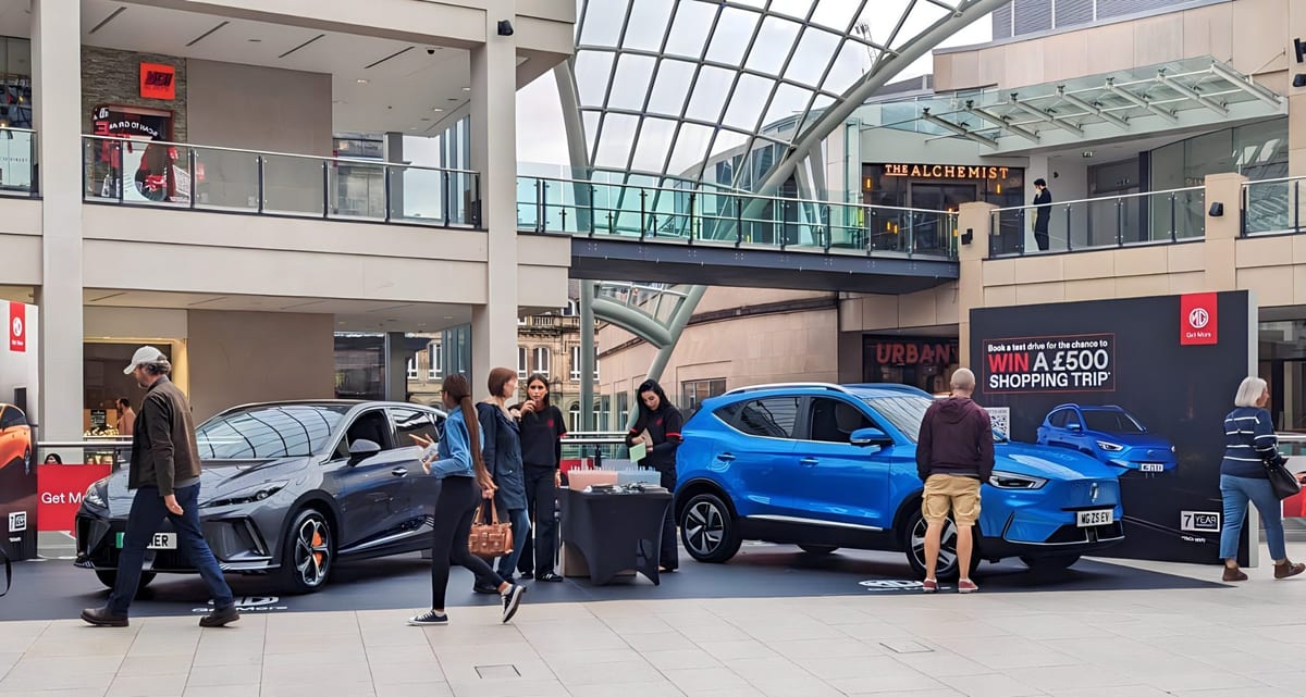 Promotional staff greeting visitors at the MG stand in Trinity Leeds