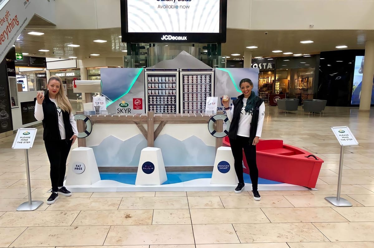 Branded product sampling stand set up inside a retail space