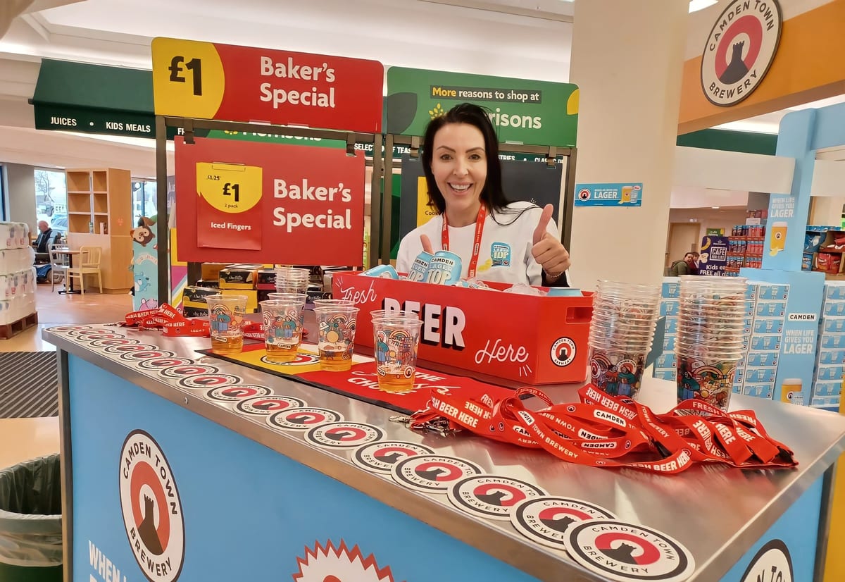 Promotional staff serving samples at the Camden Bar stand in a Morrisons store