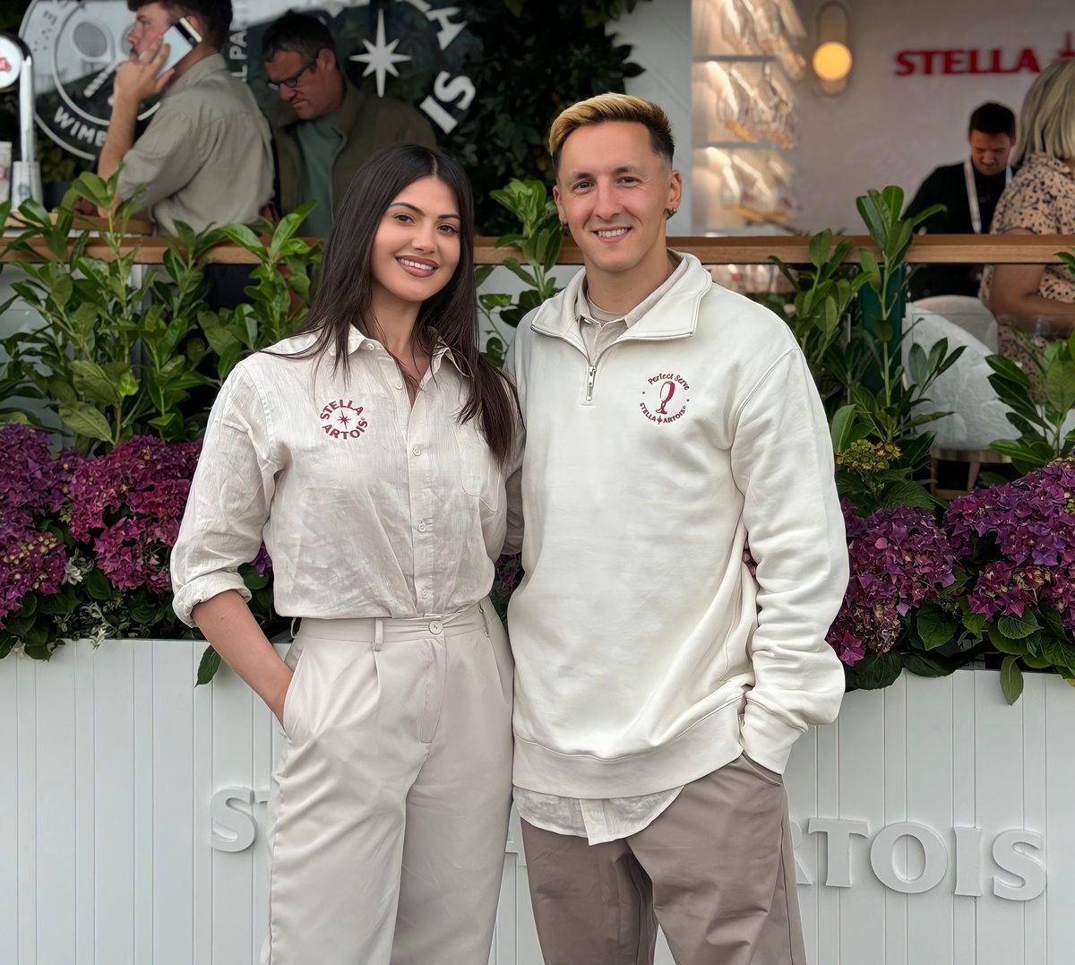 Mixed promotional team in matching white Stella Artois uniforms