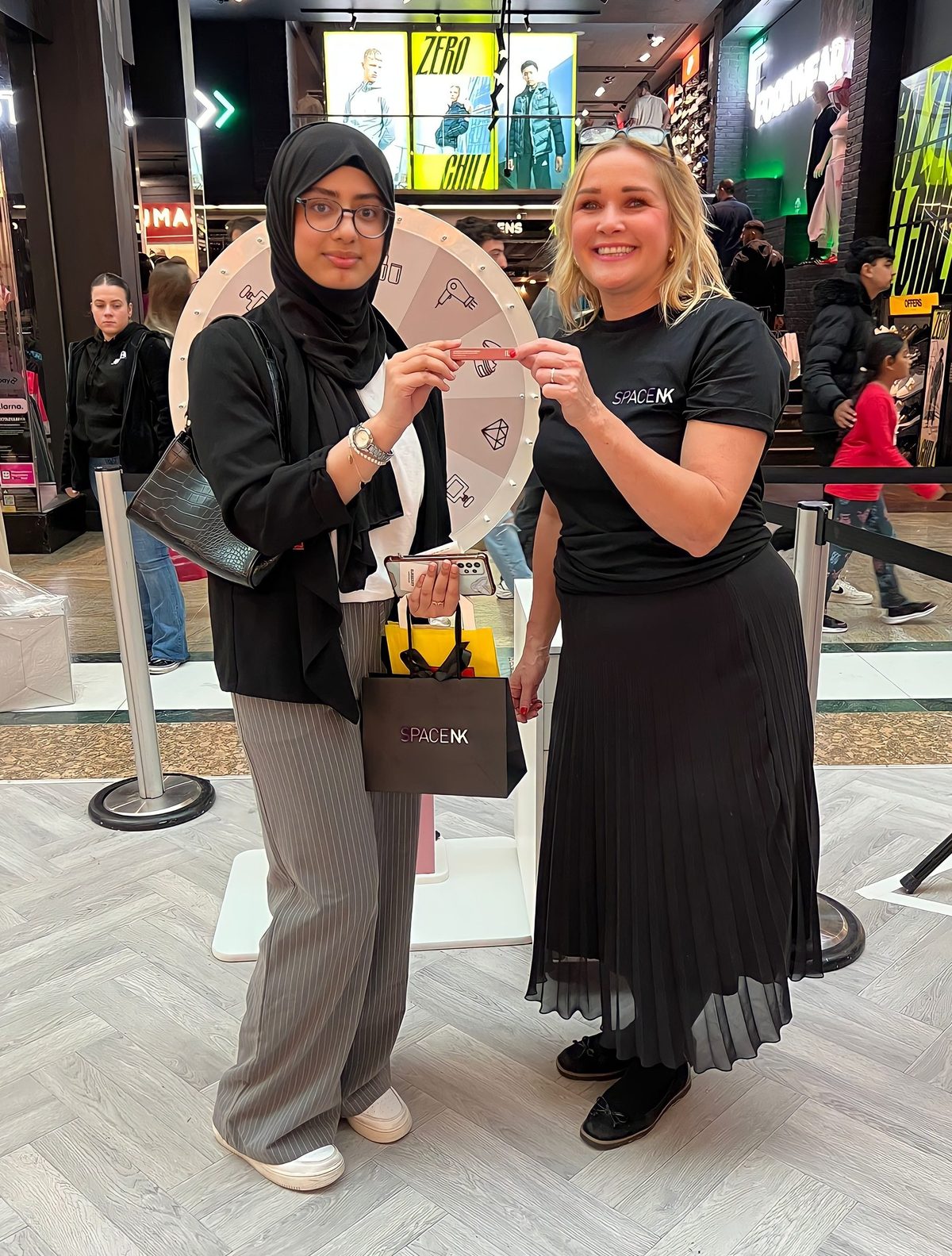 Staff member with a shopper at the Space NK store launch at the Trafford Centre