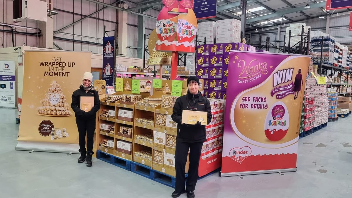 Two staff beside a seasonal chocolate display in a large store