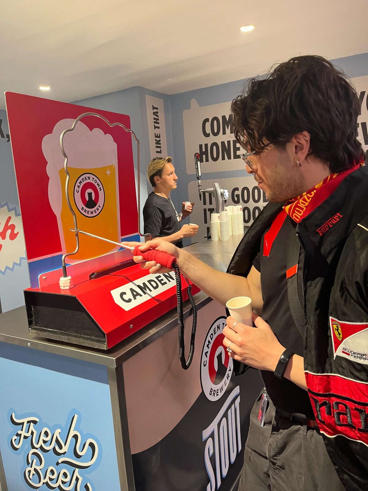 Staff member serving a customer across the counter at a concert
