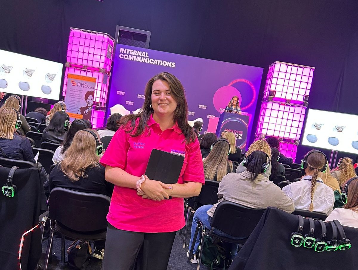 Event host in front of the stage at the Employee Engagement Summit