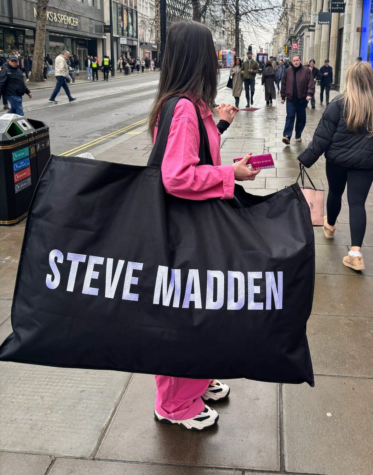 Steve Madden promotional staff member with a giant branded bag on a shopping street