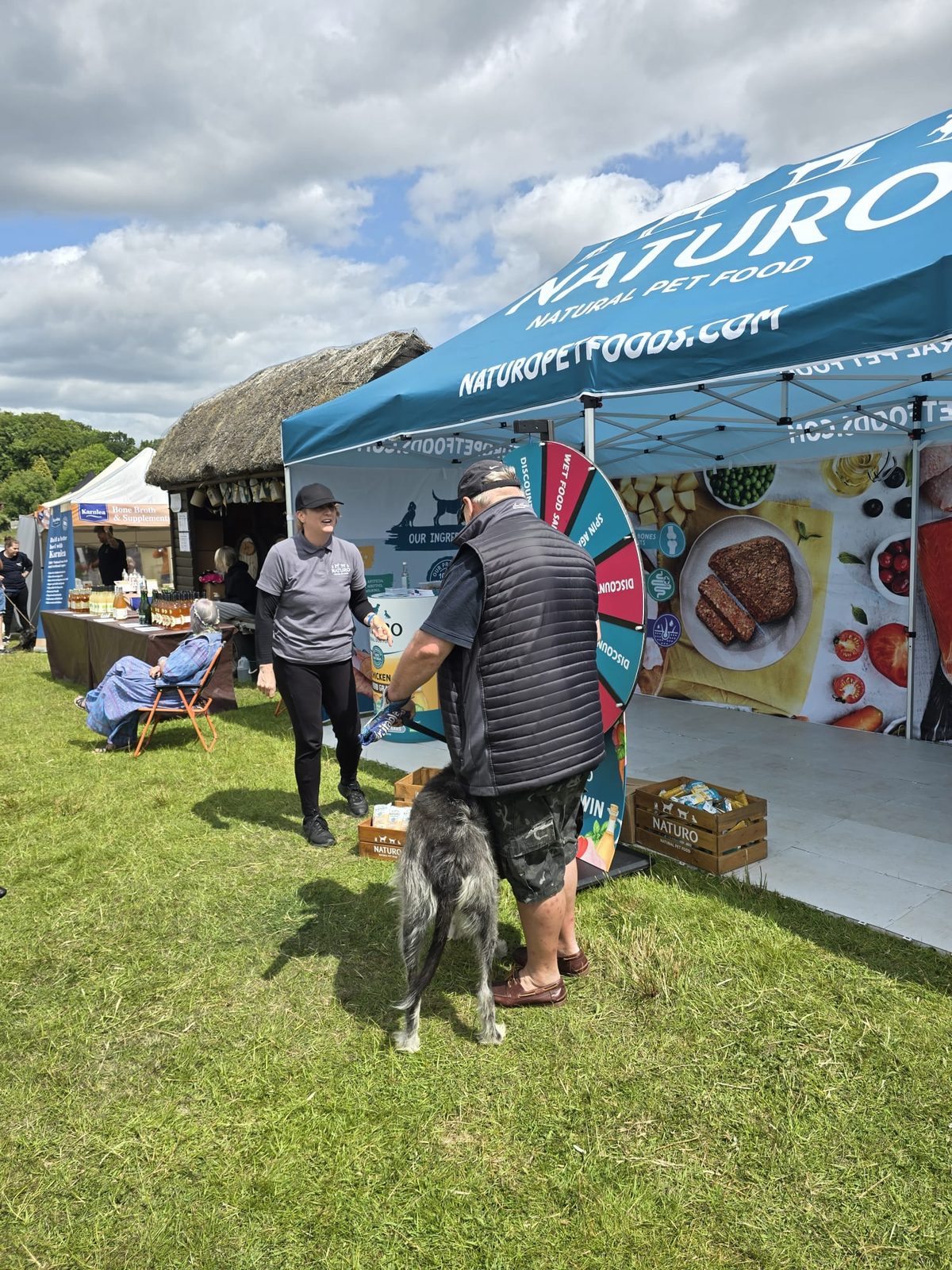 Ambassador offering Naturo samples to visitors at a pet event