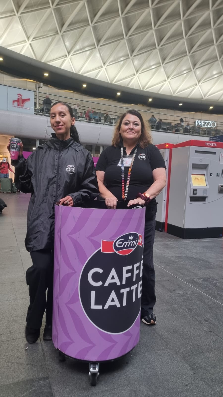 Executional sampling team handing drinks to commuters at a London station