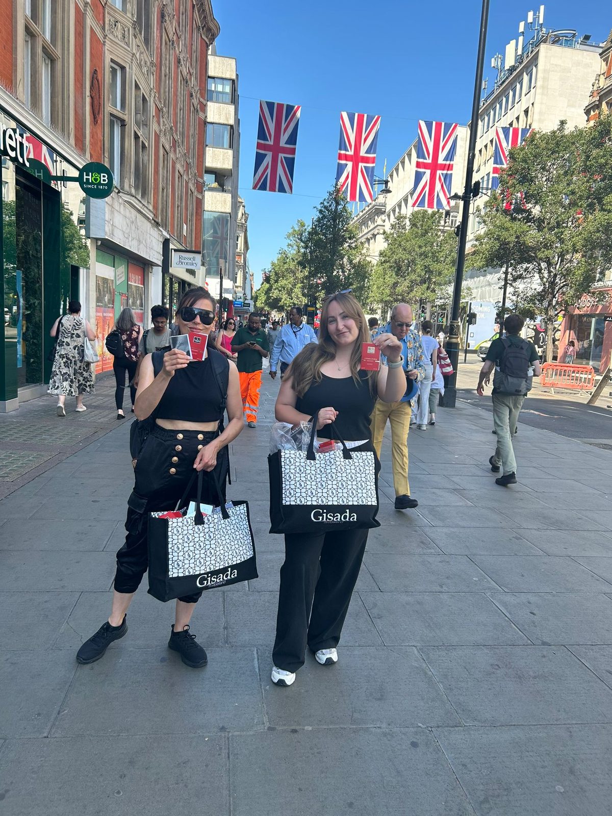 Brand ambassadors offering Gisada perfume samples on Regent Street in London