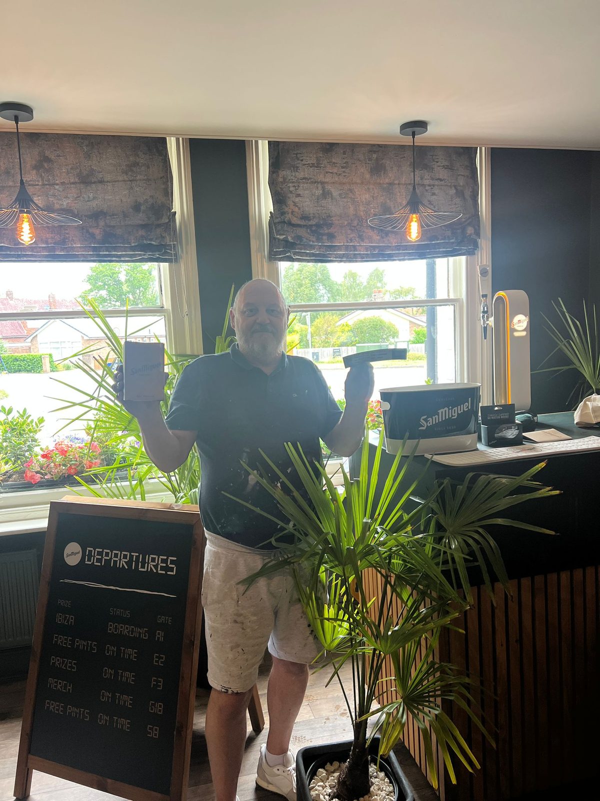 Staff serving San Miguel pints at a Liverpool pub with green barriers