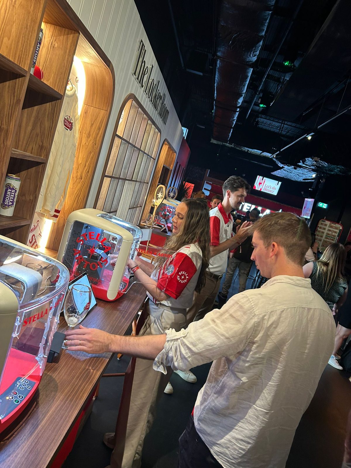 Guest pouring a Stella Artois chalice at a self-pour bar