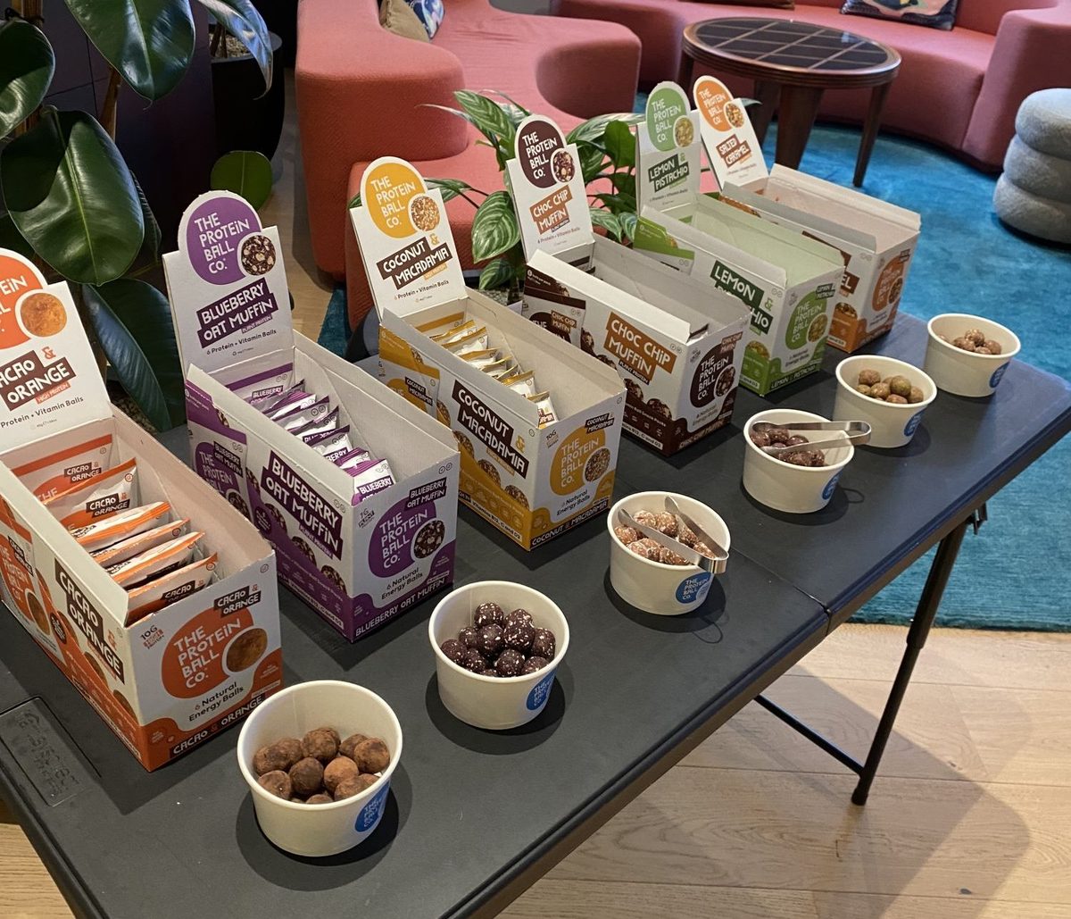 brand ambassadors offering snack samples to shoppers in a store