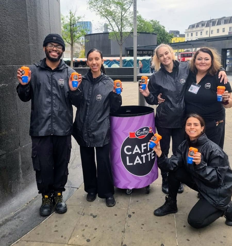 Commuters taking iced coffee samples from the Emmi team in London