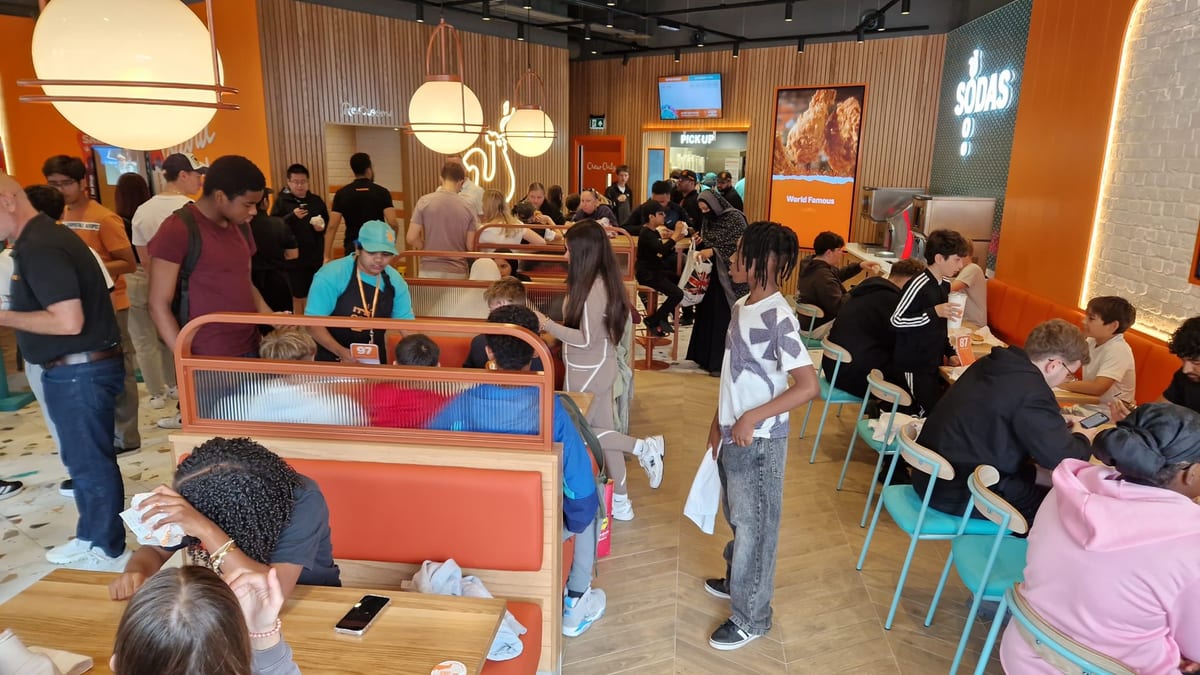 Event staff leading a countdown with the crowd at a restaurant opening