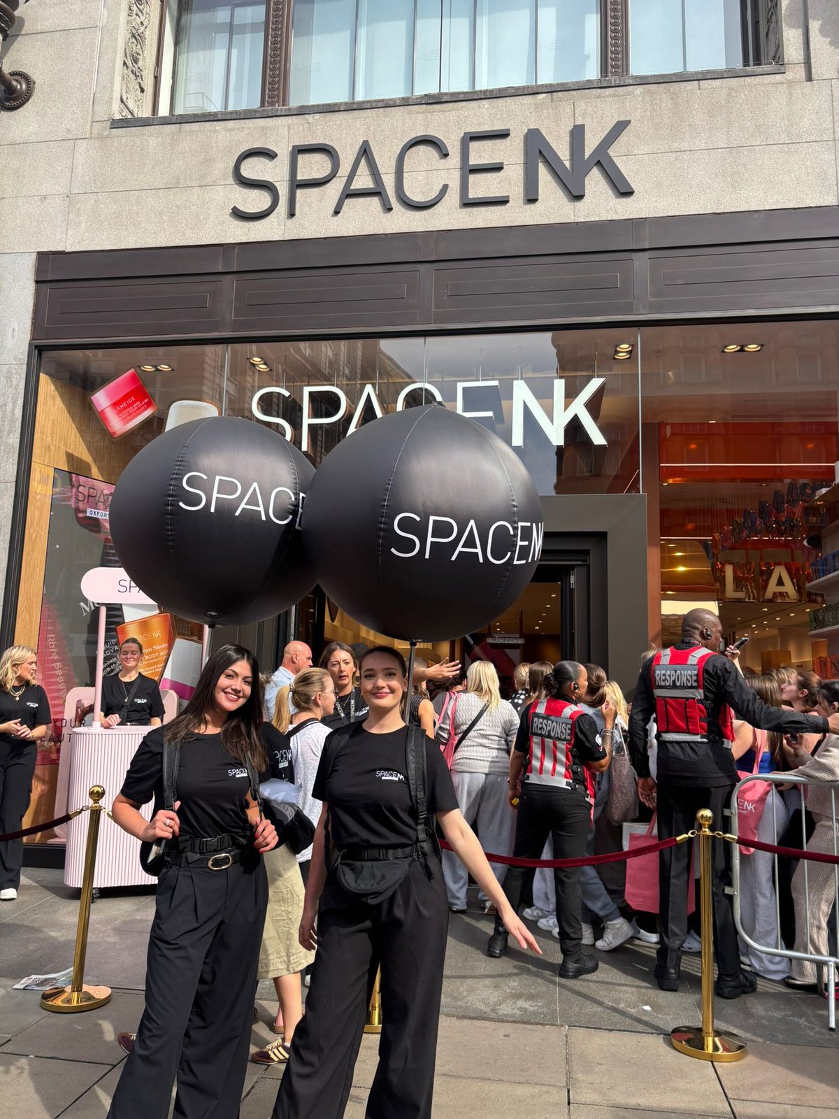 Executional team welcoming shoppers to a London store opening