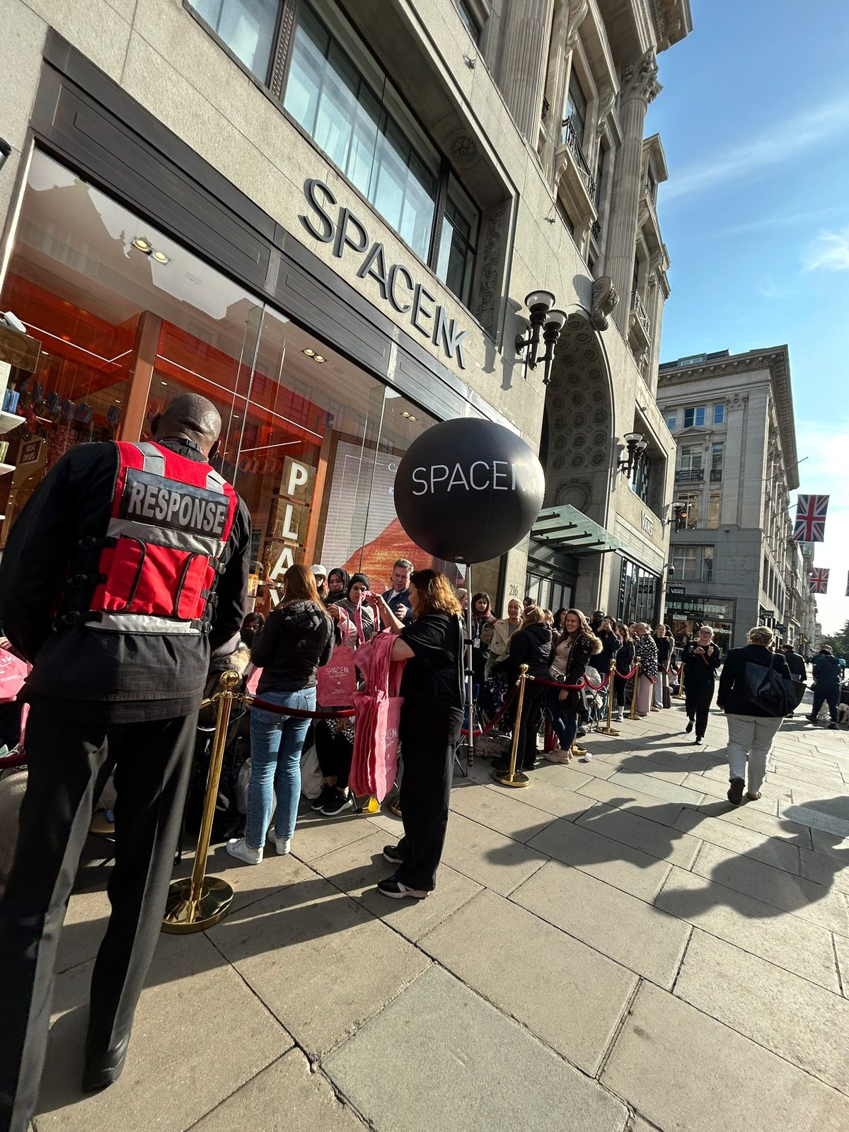 Executional door team managing a launch queue outside a London store