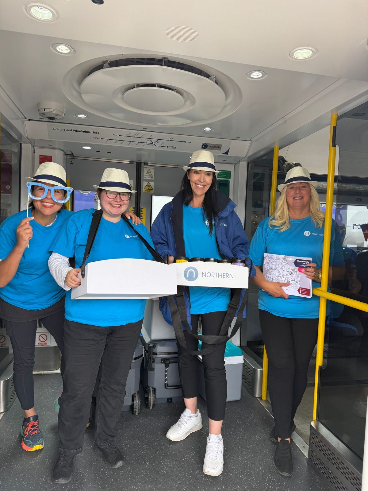 Four Northern Rail brand ambassadors briefed and ready on board a train