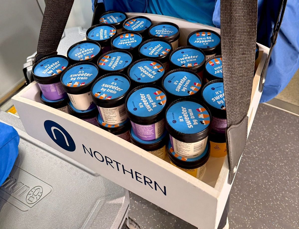 Ambassadors handing ice creams to passengers aboard a Northern train