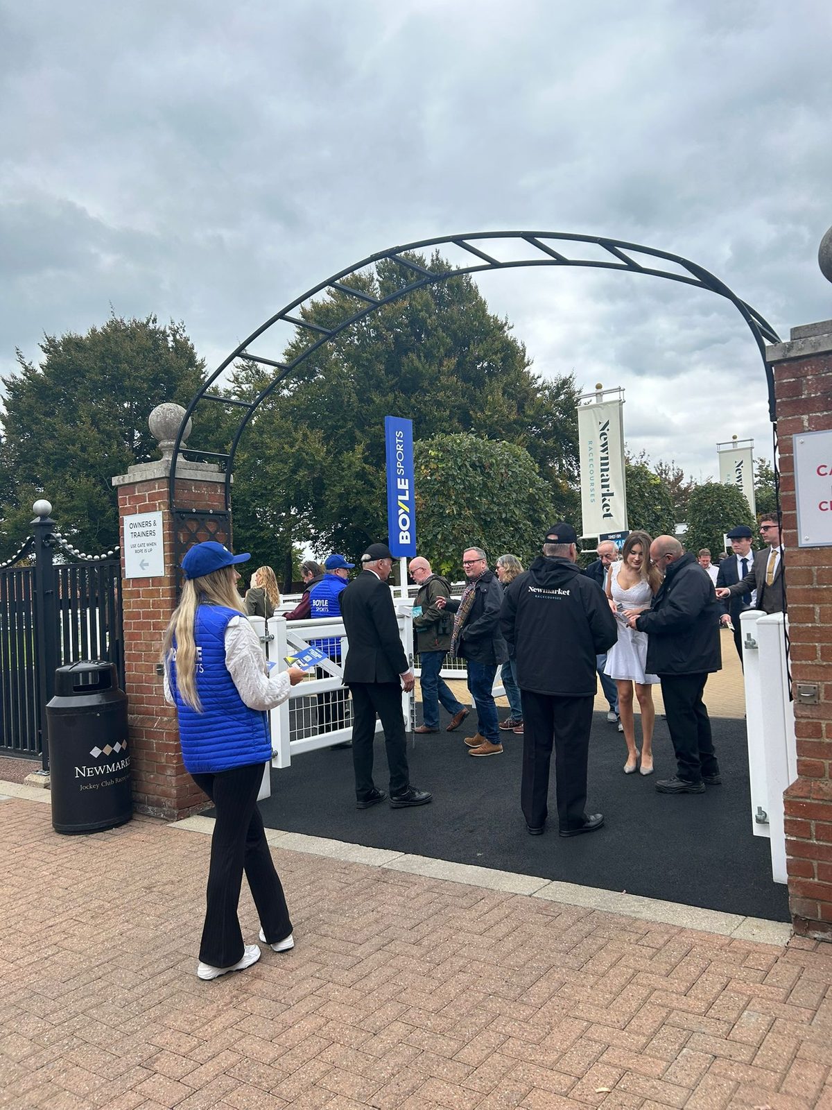 Leaflet distribution staff in a busy social area at the races