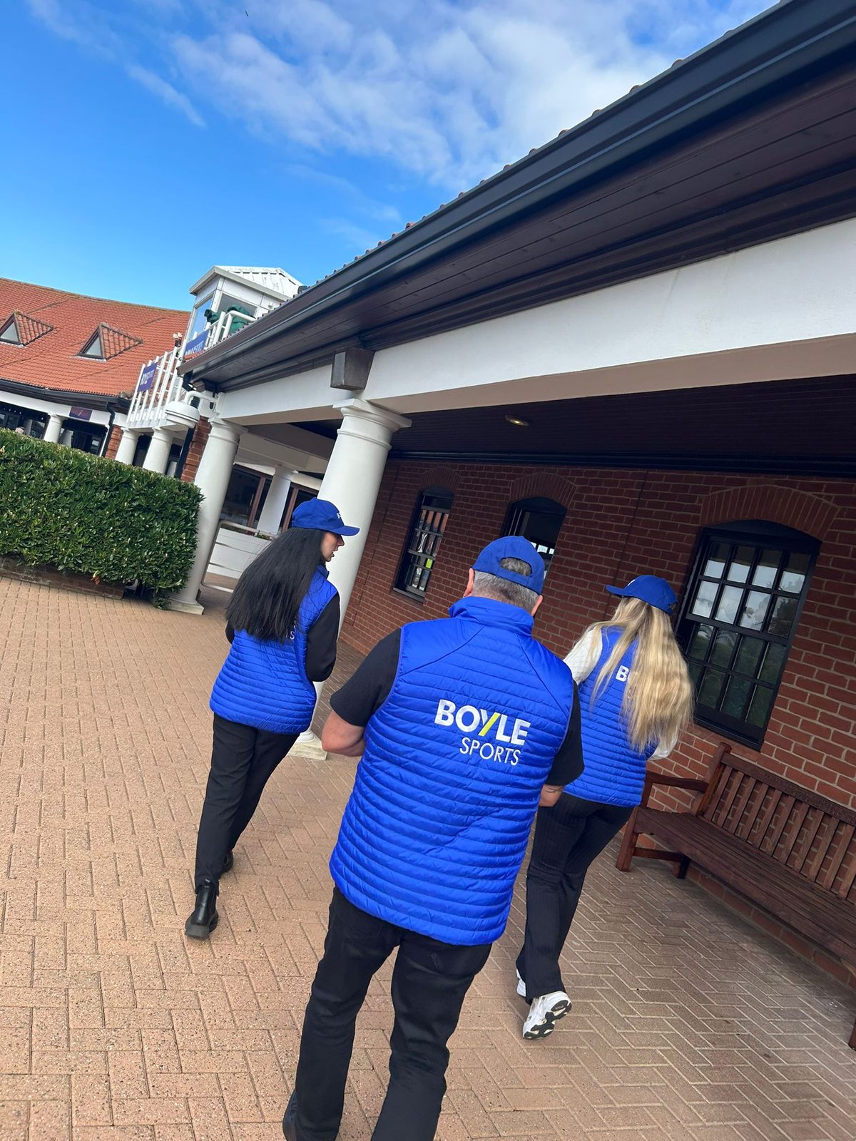 Racegoers receiving BoyleSports leaflets near the course