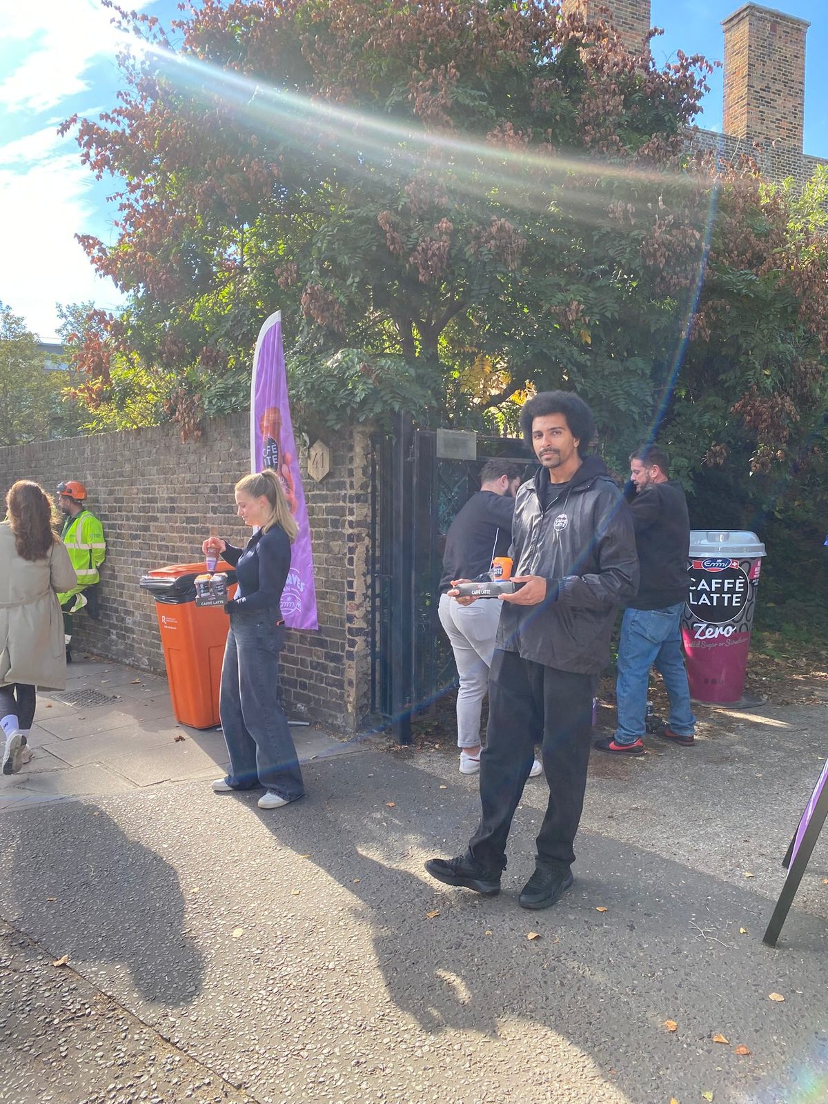 sampling team handing iced coffee to rugby fans outside the stadium