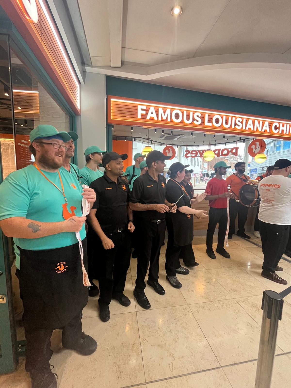 Team lined up inside the Popeyes restaurant in Basingstoke on opening day