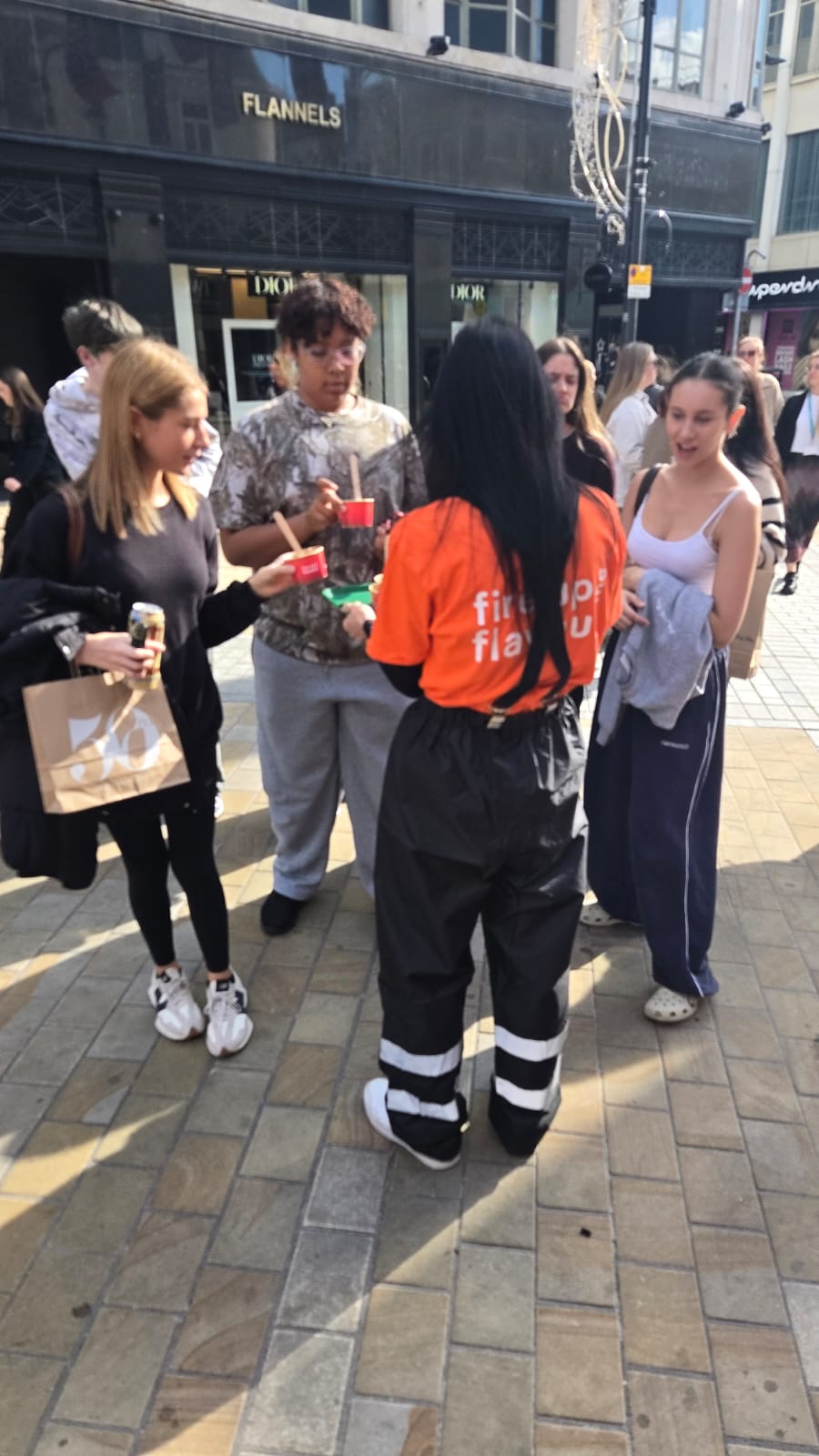 Executional team engaging shoppers on a Leeds high street