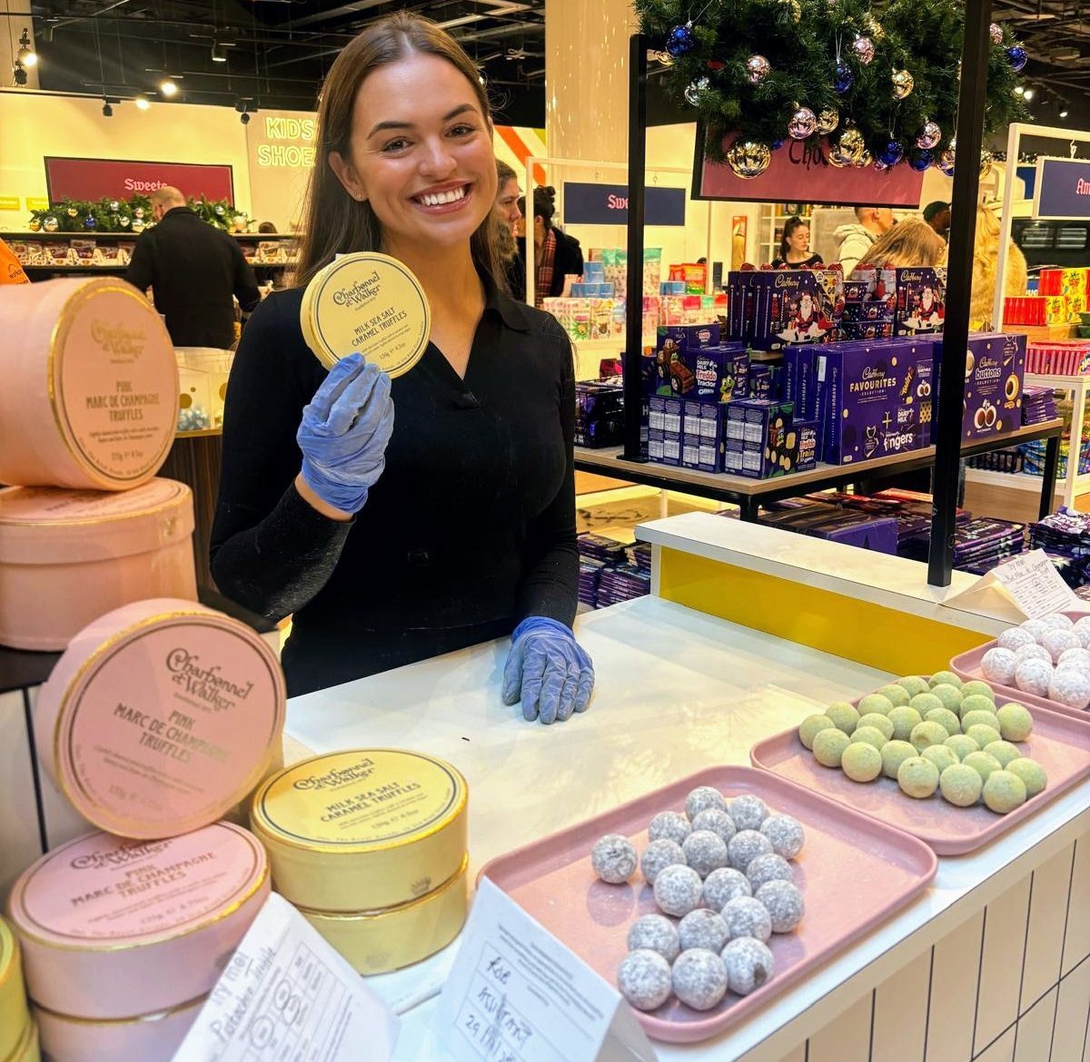 Staff member at a Charbonnel et Walker tasting counter in store