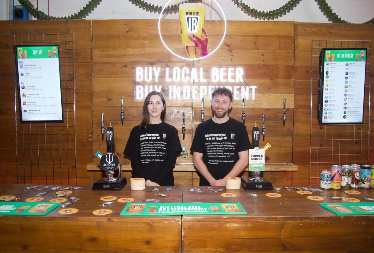 Two event staff in matching black T-shirts at the British Guild of Beer Writers awards