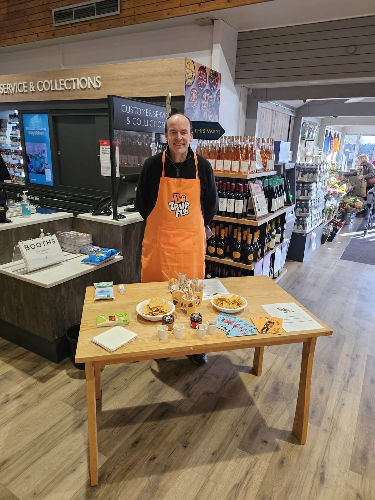 Be Truffle tasting staff member at a table in a Booths store