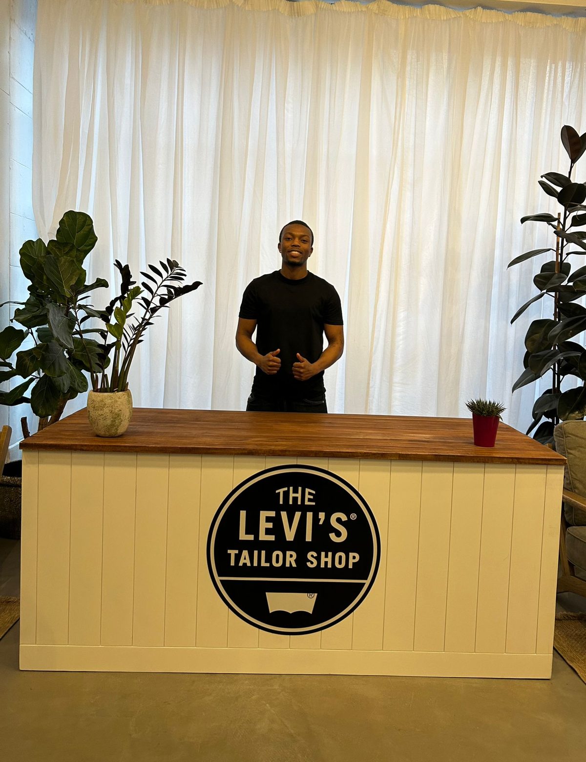 Staff member behind the Levi's Tailor Shop counter in a London store