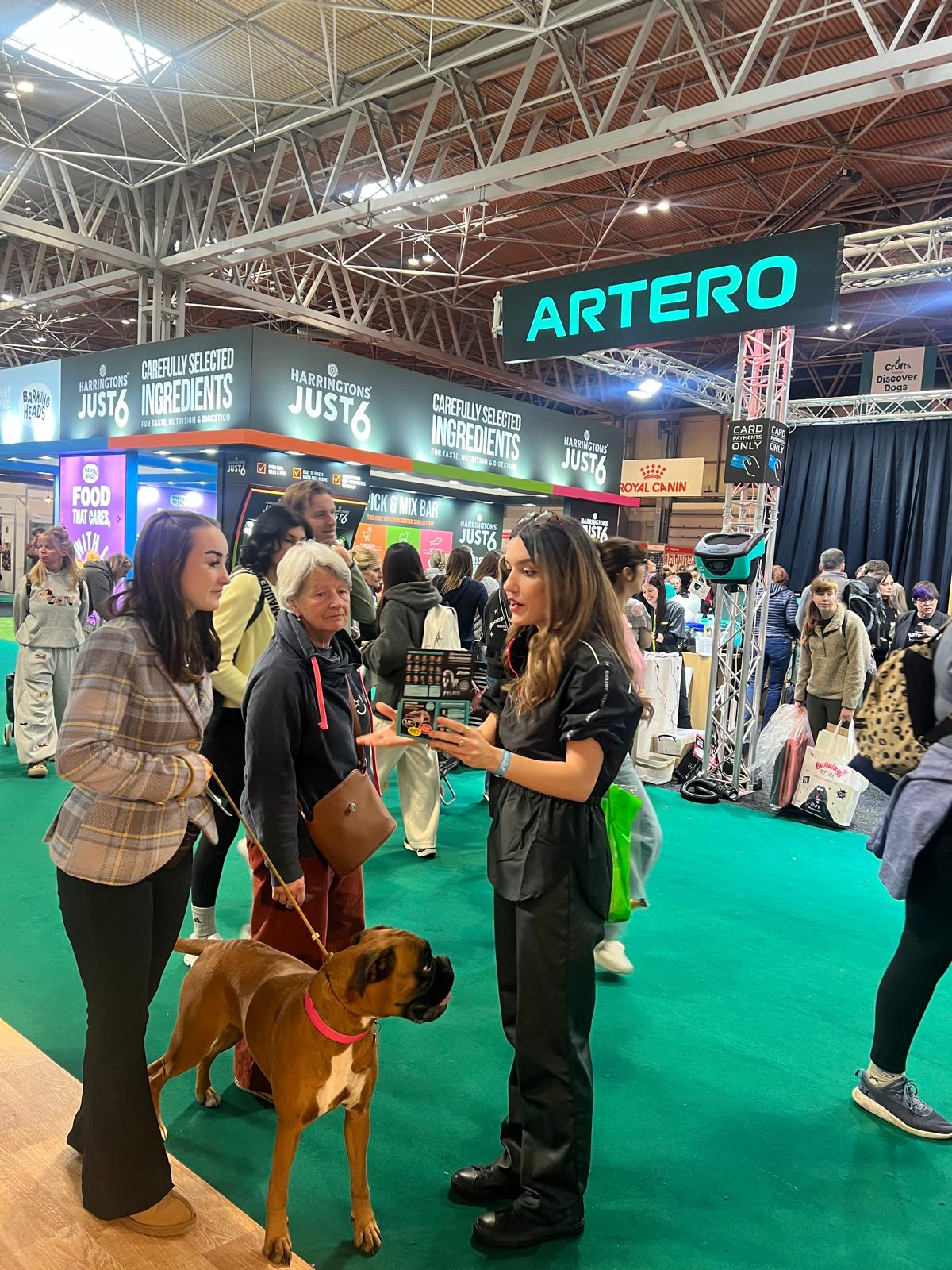 Visitors being welcomed to the Artero grooming stand