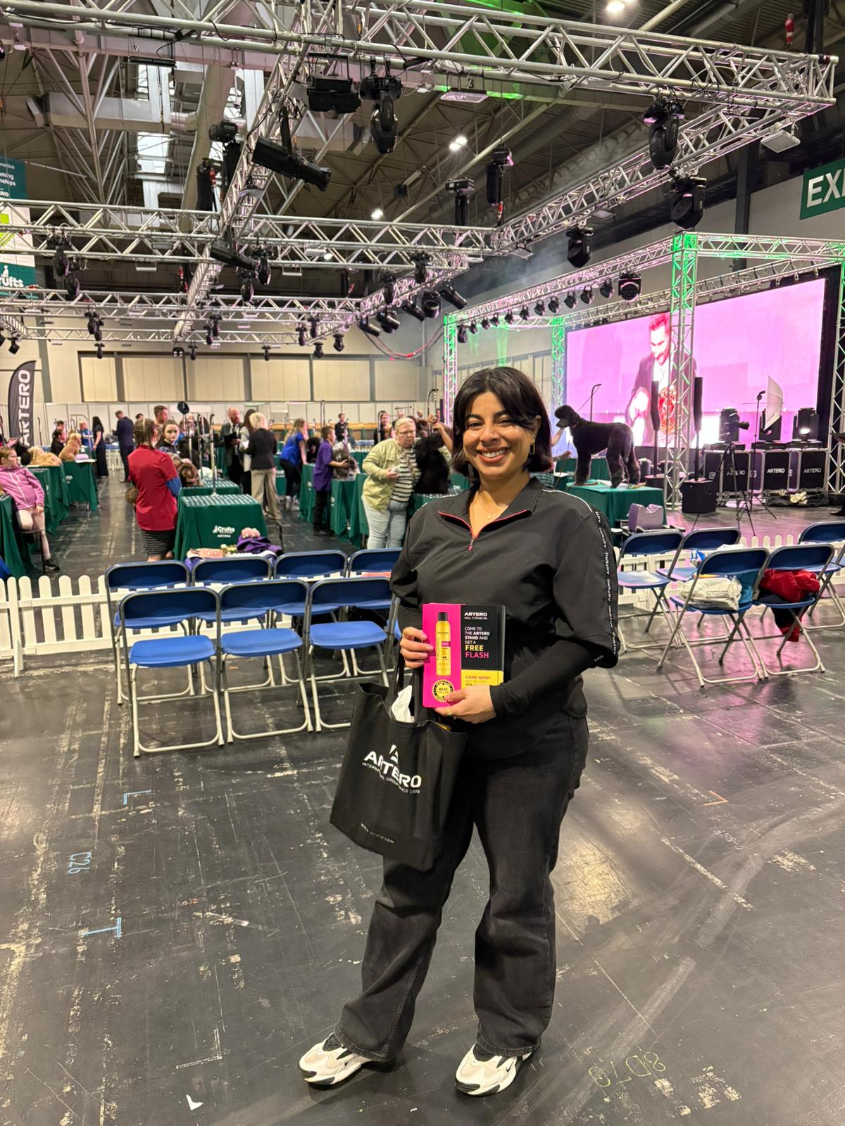 Staff handing leaflets to dog lovers walking the Crufts halls