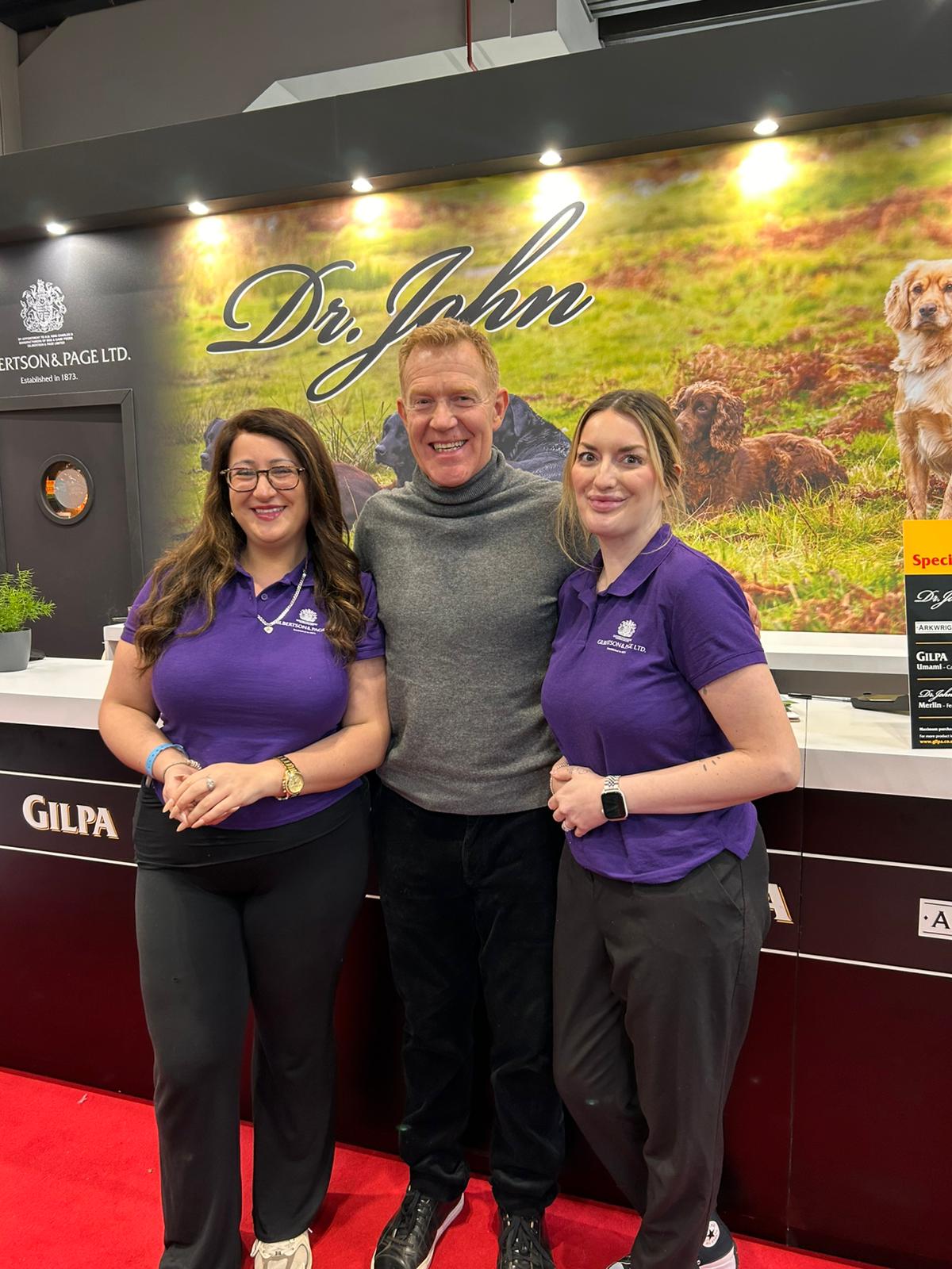 Exhibition staff welcoming dog owners at the Gilbertson & Page stand at the NEC Birmingham