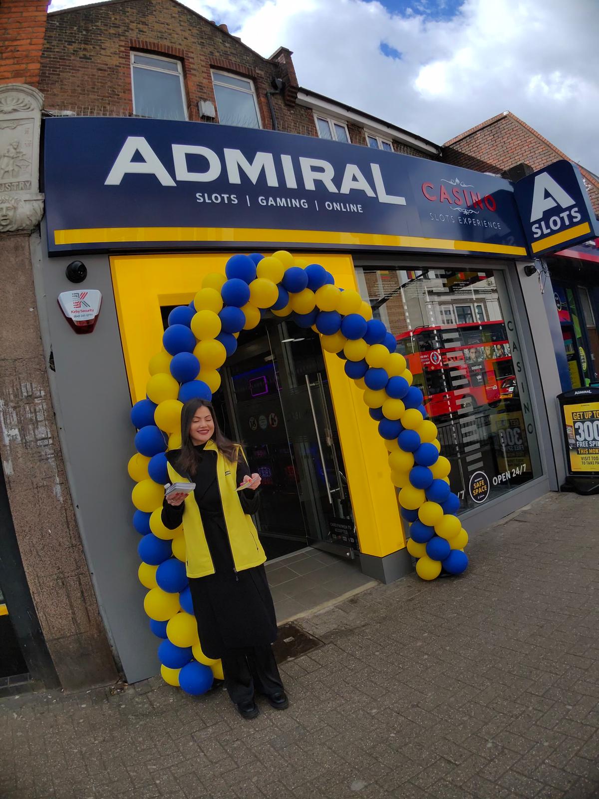Admiral promotional staff member with leaflets at the venue entrance on a high street