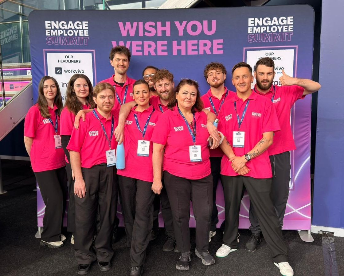 Team of conference hosts in matching pink polo shirts at the Engage Employee Summit in London