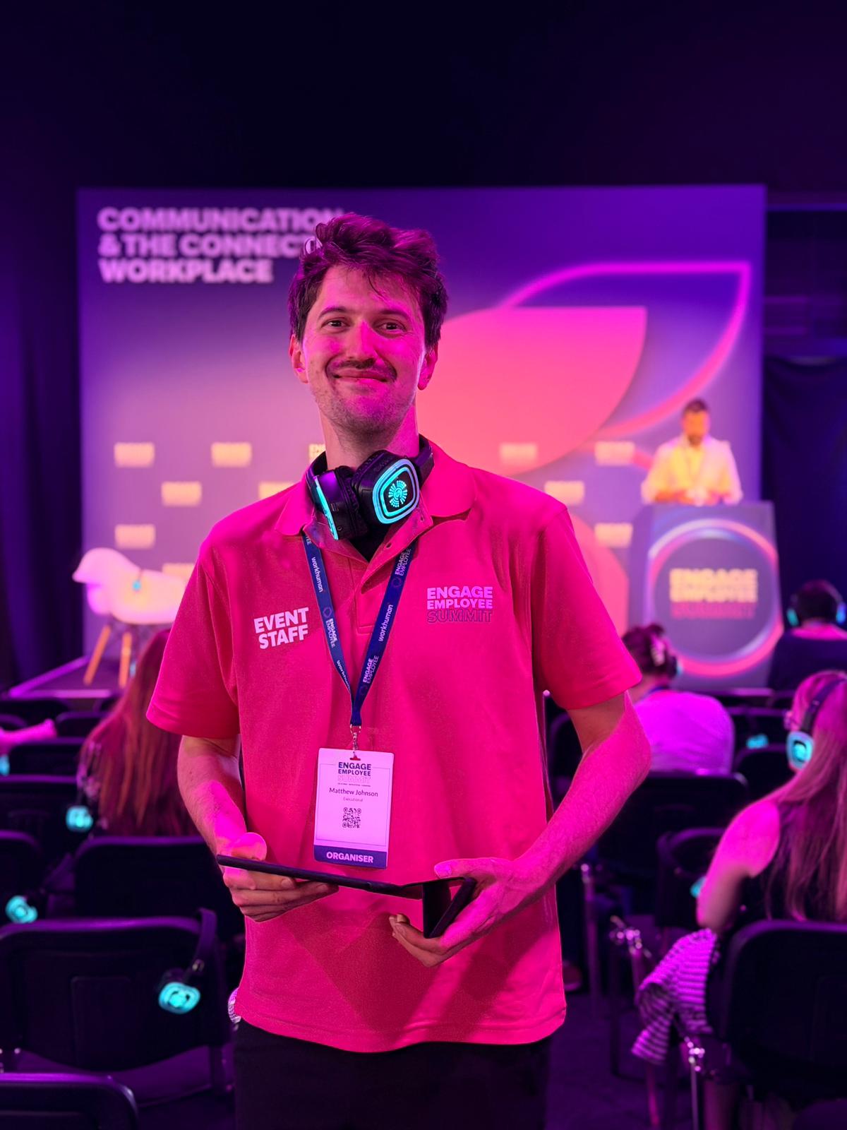 Conference host with a tablet and headphones in a session room in London