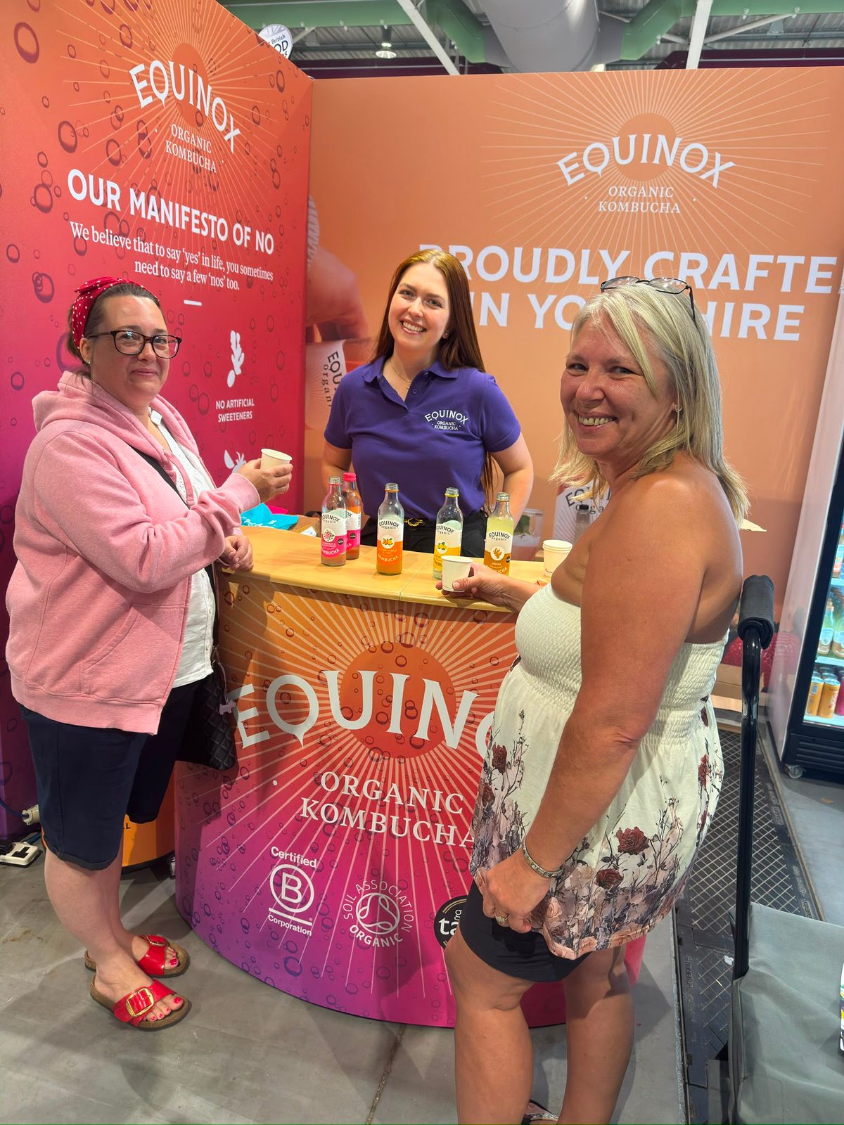 Staff selling cans of kombucha from the stand in Harrogate
