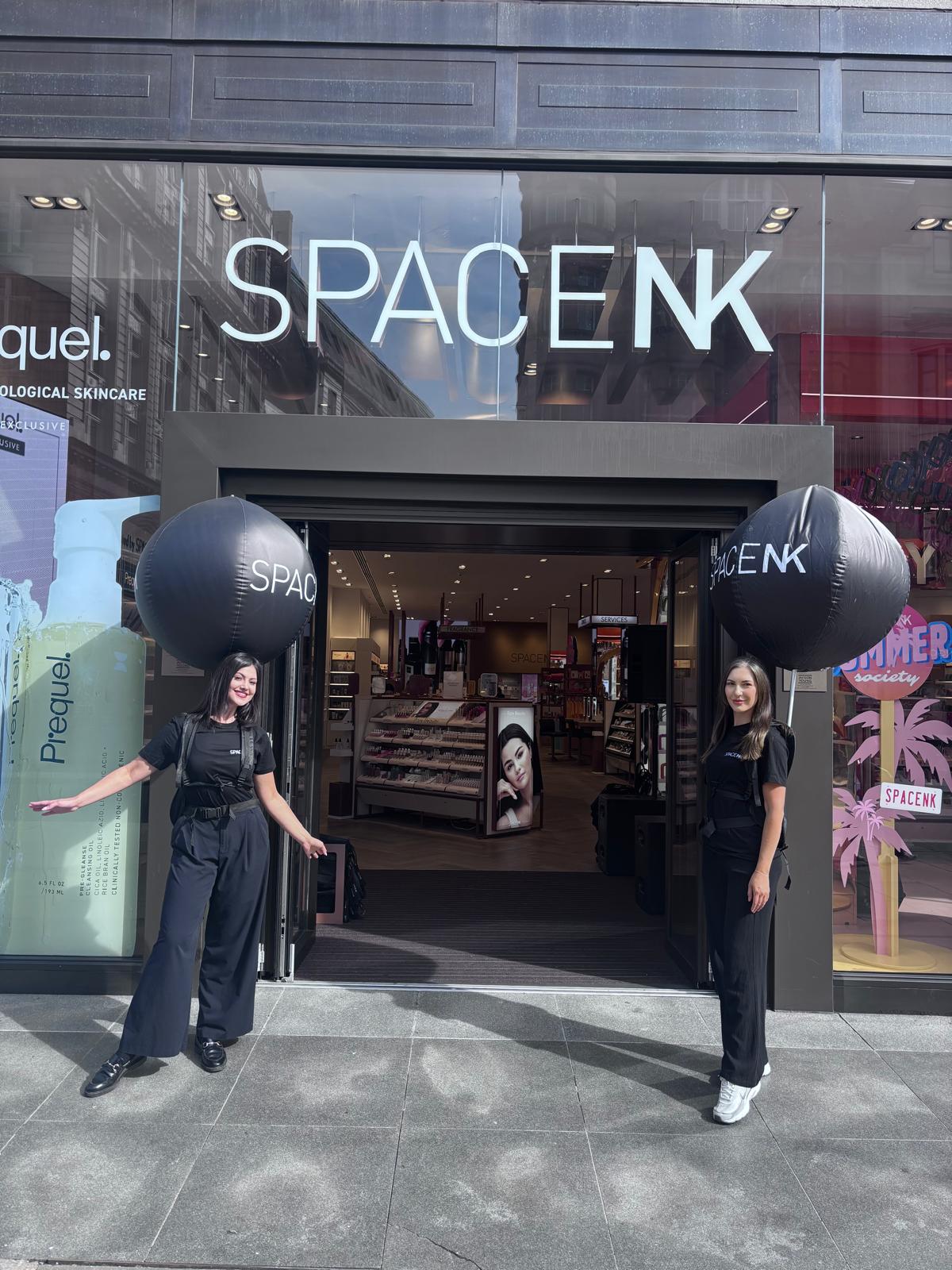 Two staff in matching black outside a Space NK store