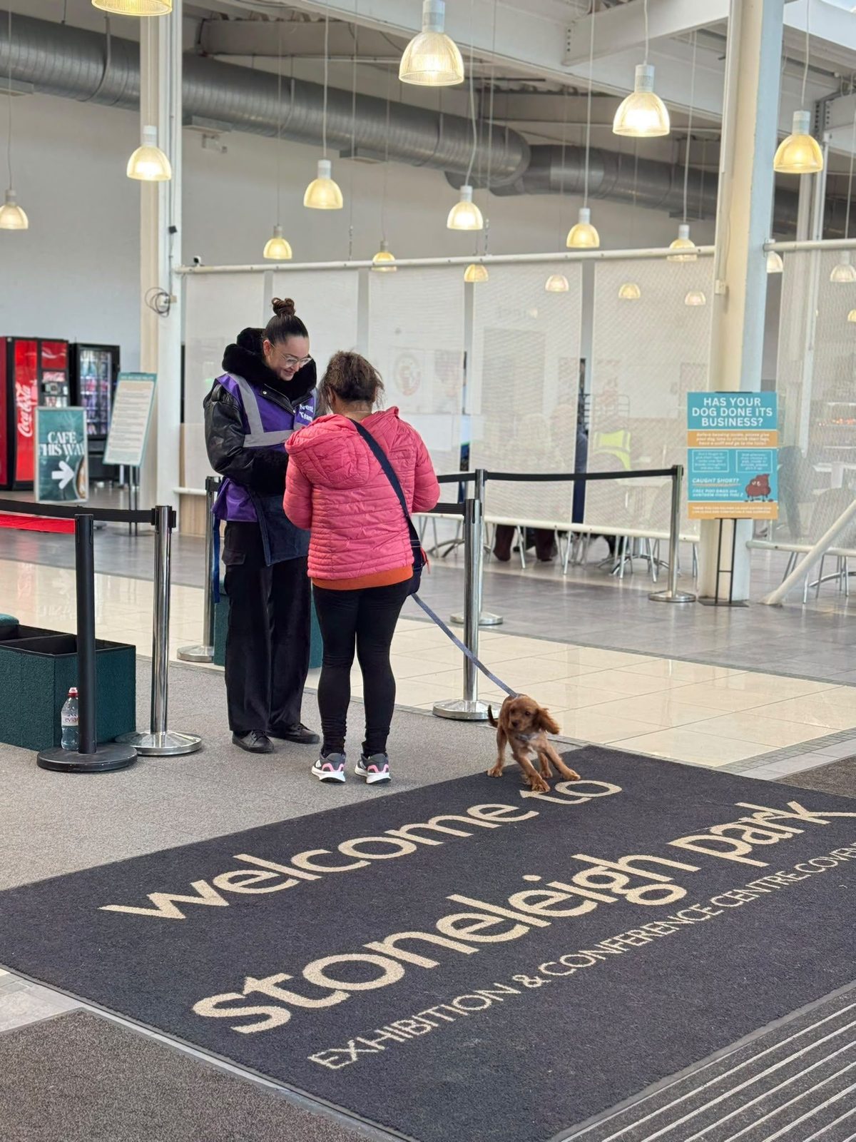 Welcome staff scanning a visitor's ticket as she arrives with her dog at Stoneleigh Park
