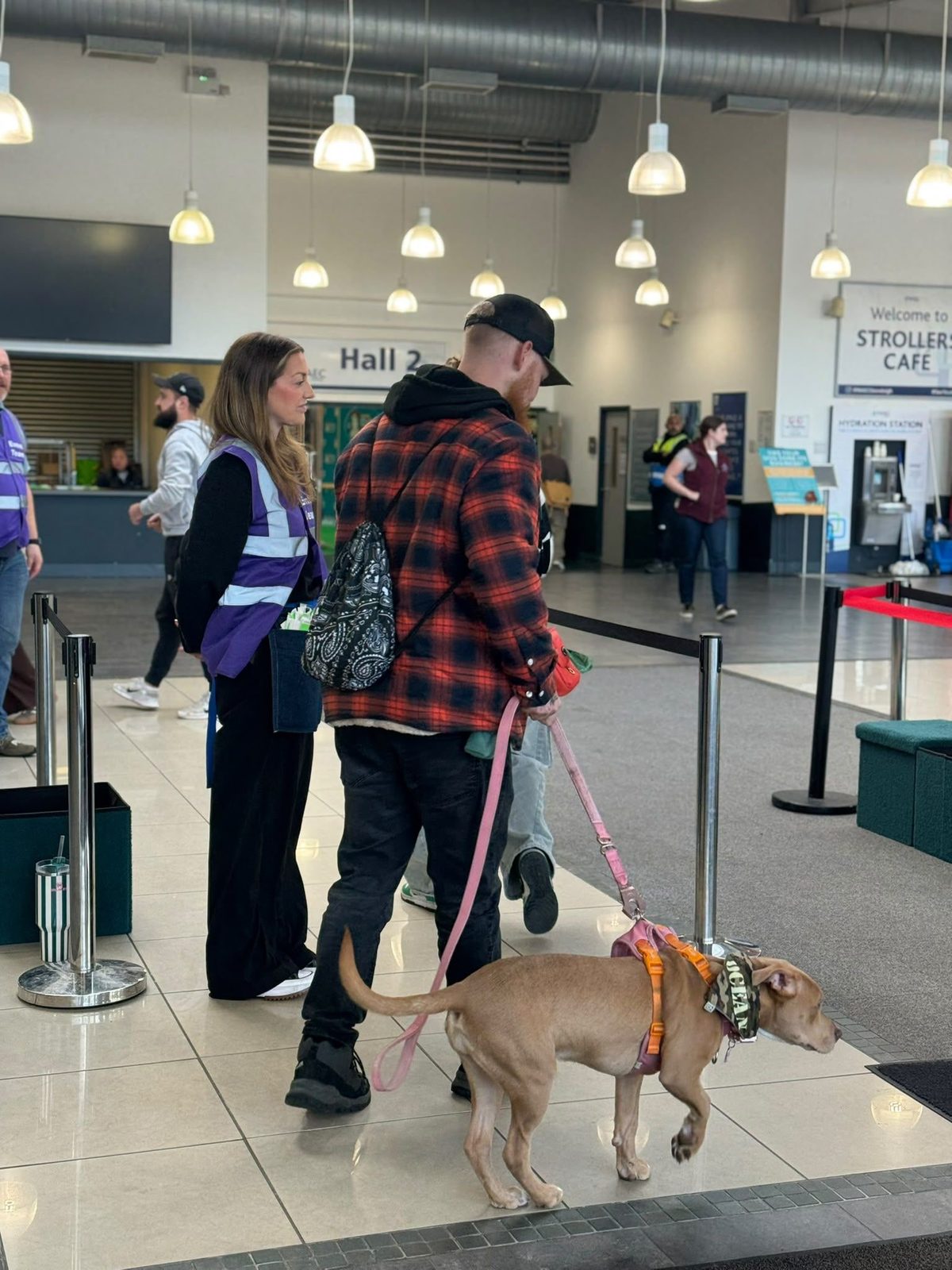 Welcome staff checking in a dog owner at the Edition Dog Live entrance