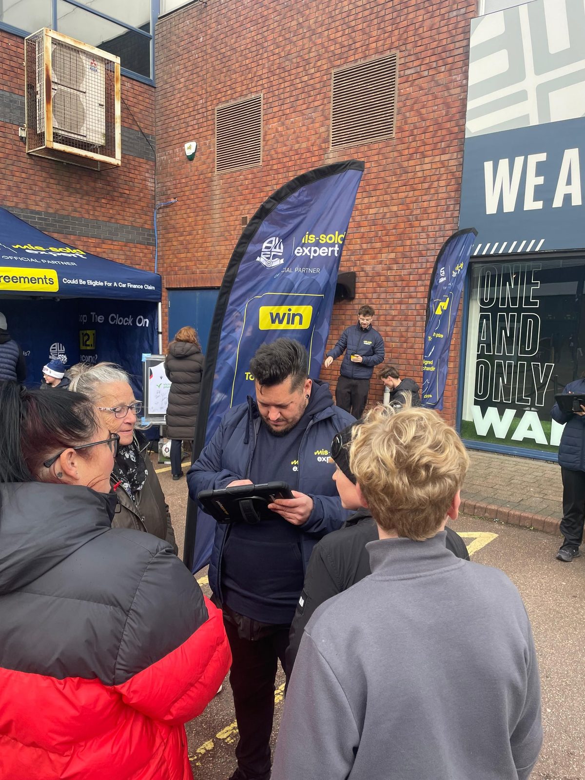 Brand ambassador registering fans on an iPad before they play The 12.1 Challenge